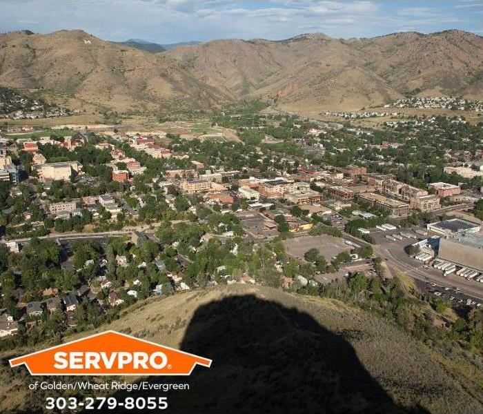 The shadow of Castle Rock stretches towards the city of Golden, Colorado.
