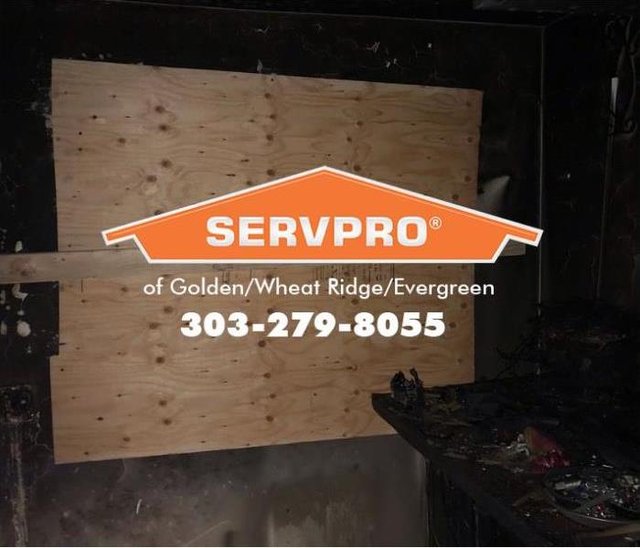 A home recently damaged by fire has been boarded up by SERVPRO technicians.